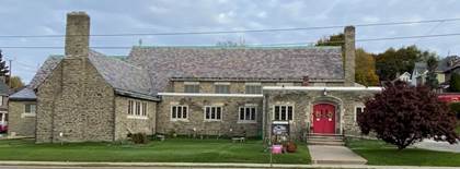 A stone building with a red door

Description automatically generated with low confidence